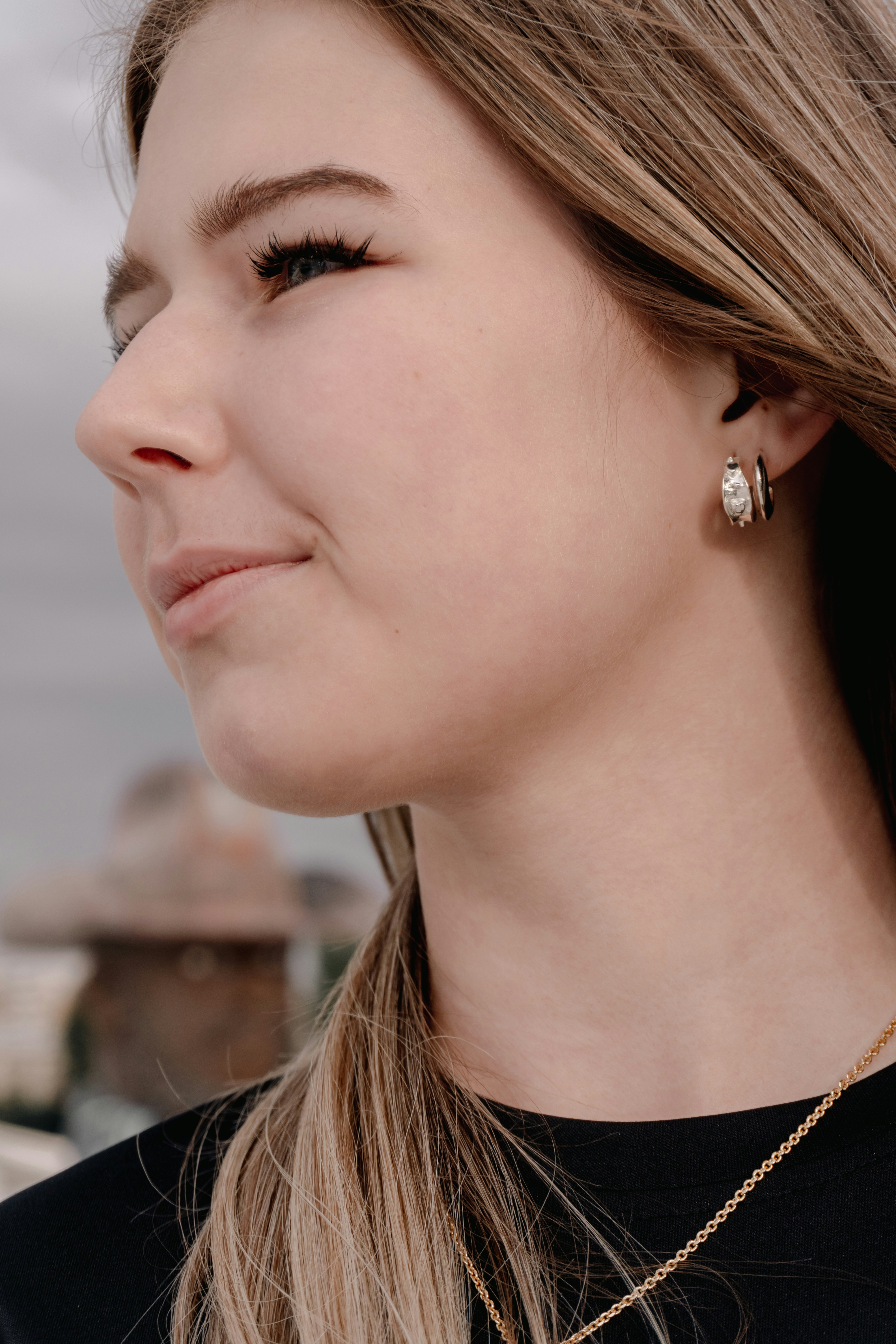 Young woman with blonde hair and earrings