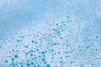 Blue bubbles on a white surface