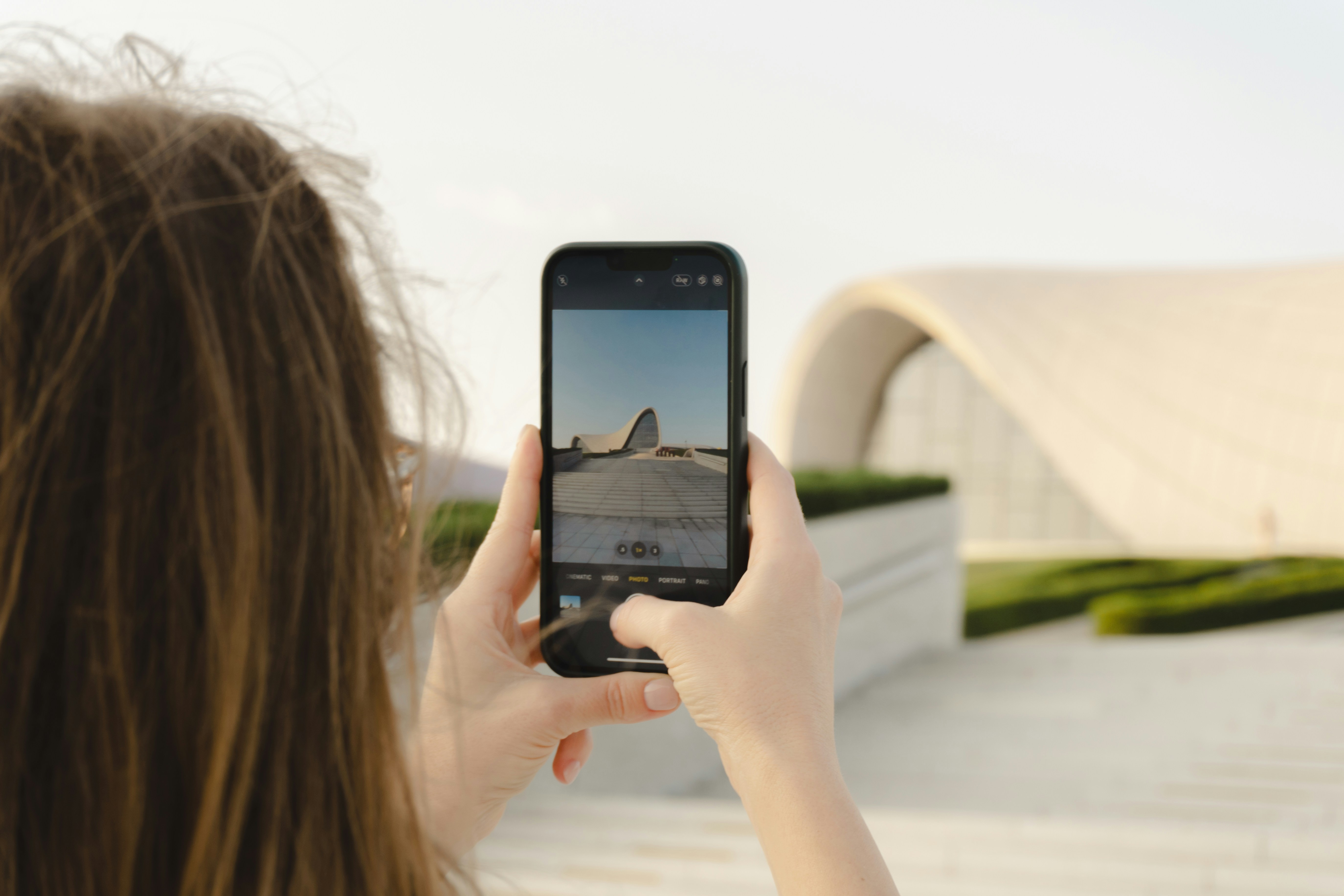 Woman takes a picture of a modern building