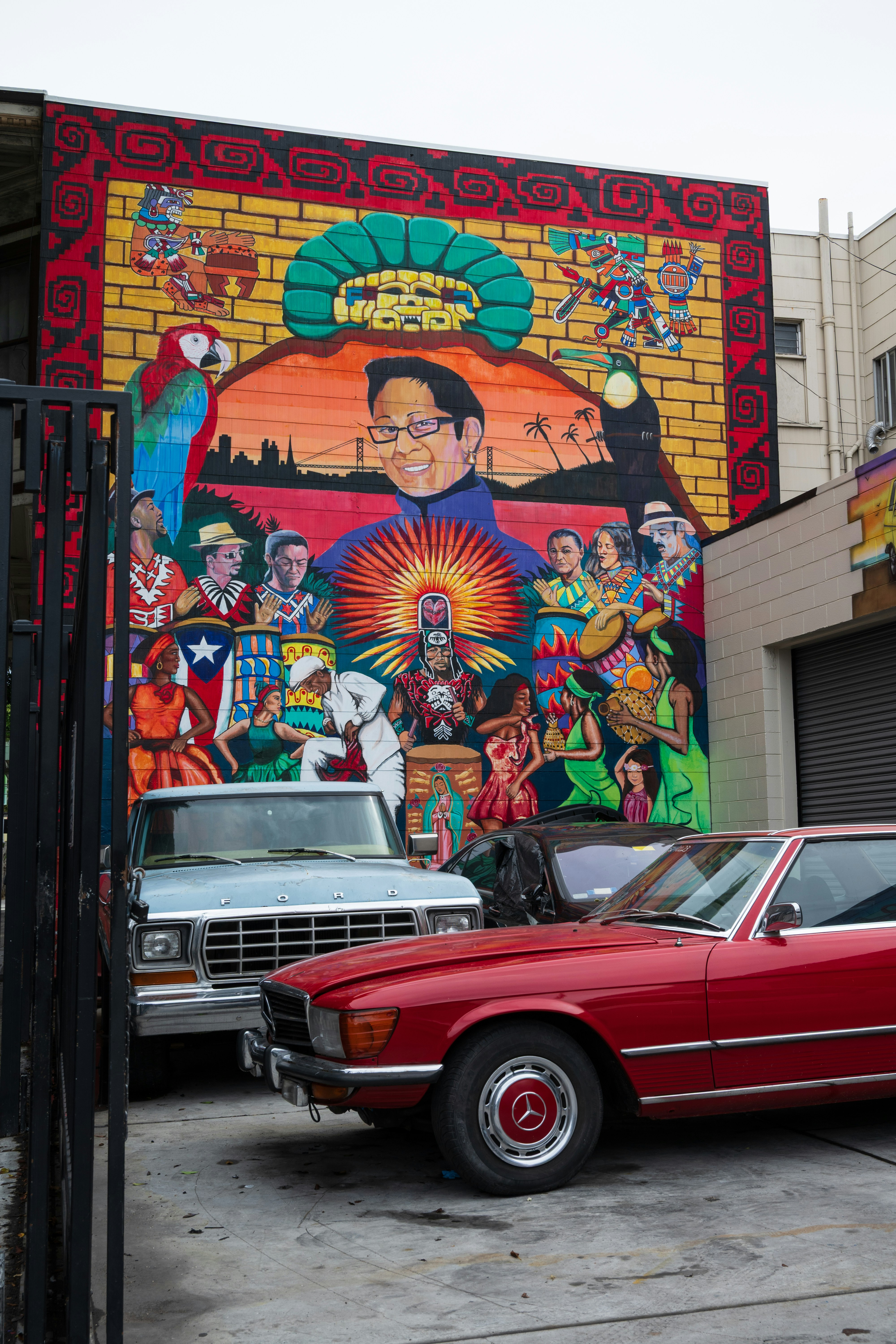 Colorful mural depicts diverse people and city skyline.