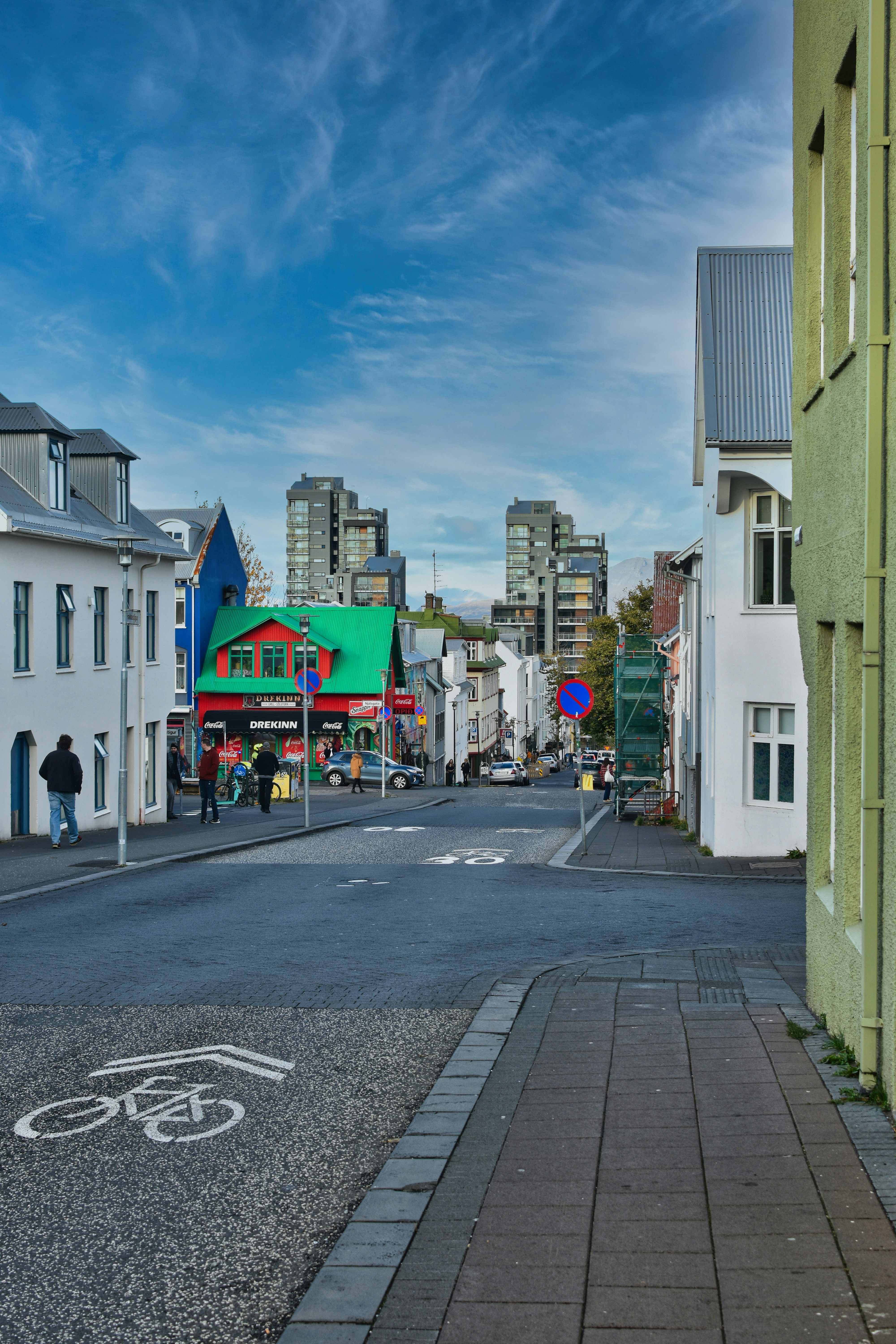 Street scene with colorful buildings and distant city skyline