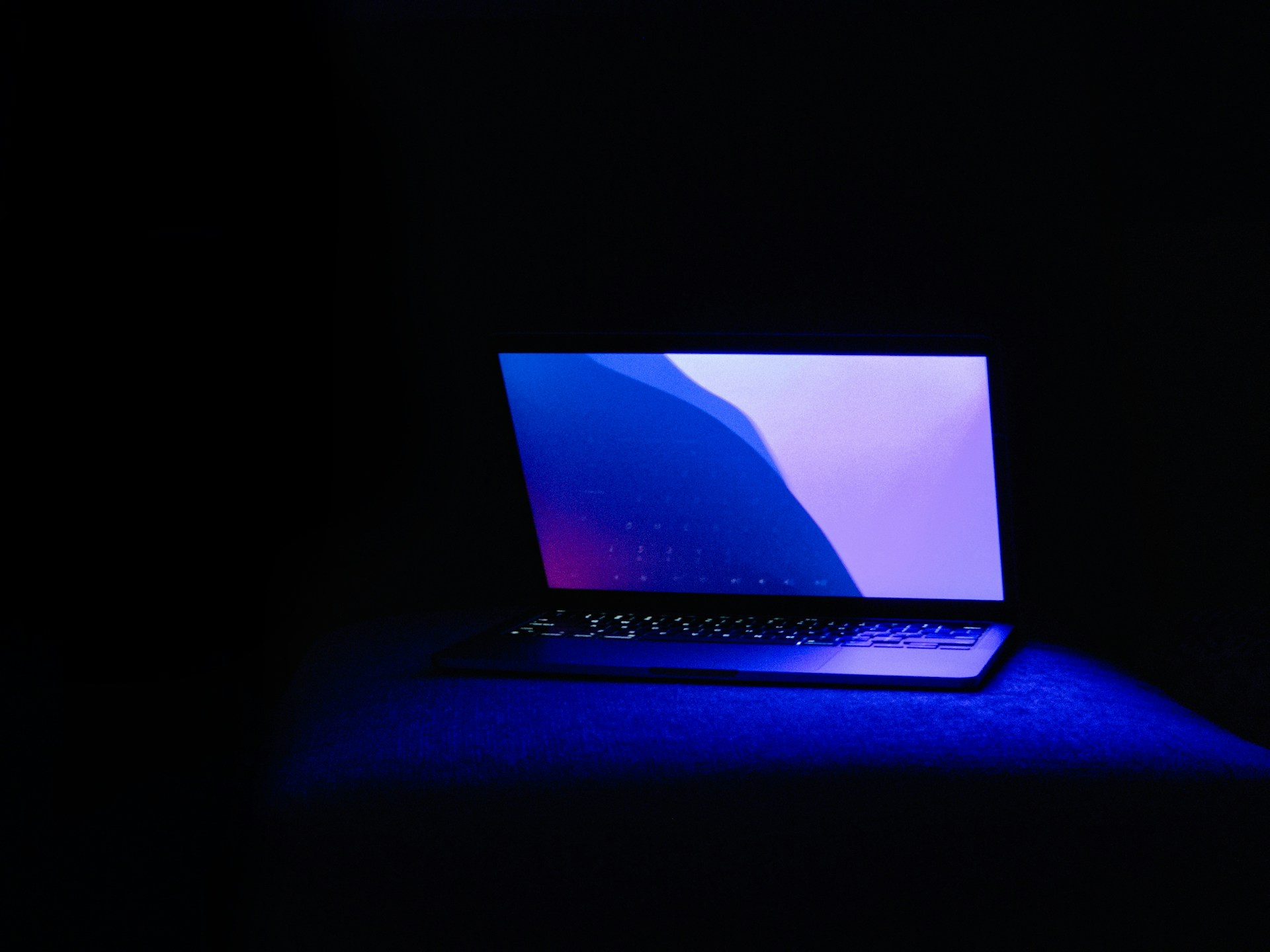 Laptop with glowing keyboard and blue light