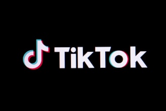 The tiktok logo on a black background