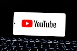 Youtube logo displayed on a smartphone screen.