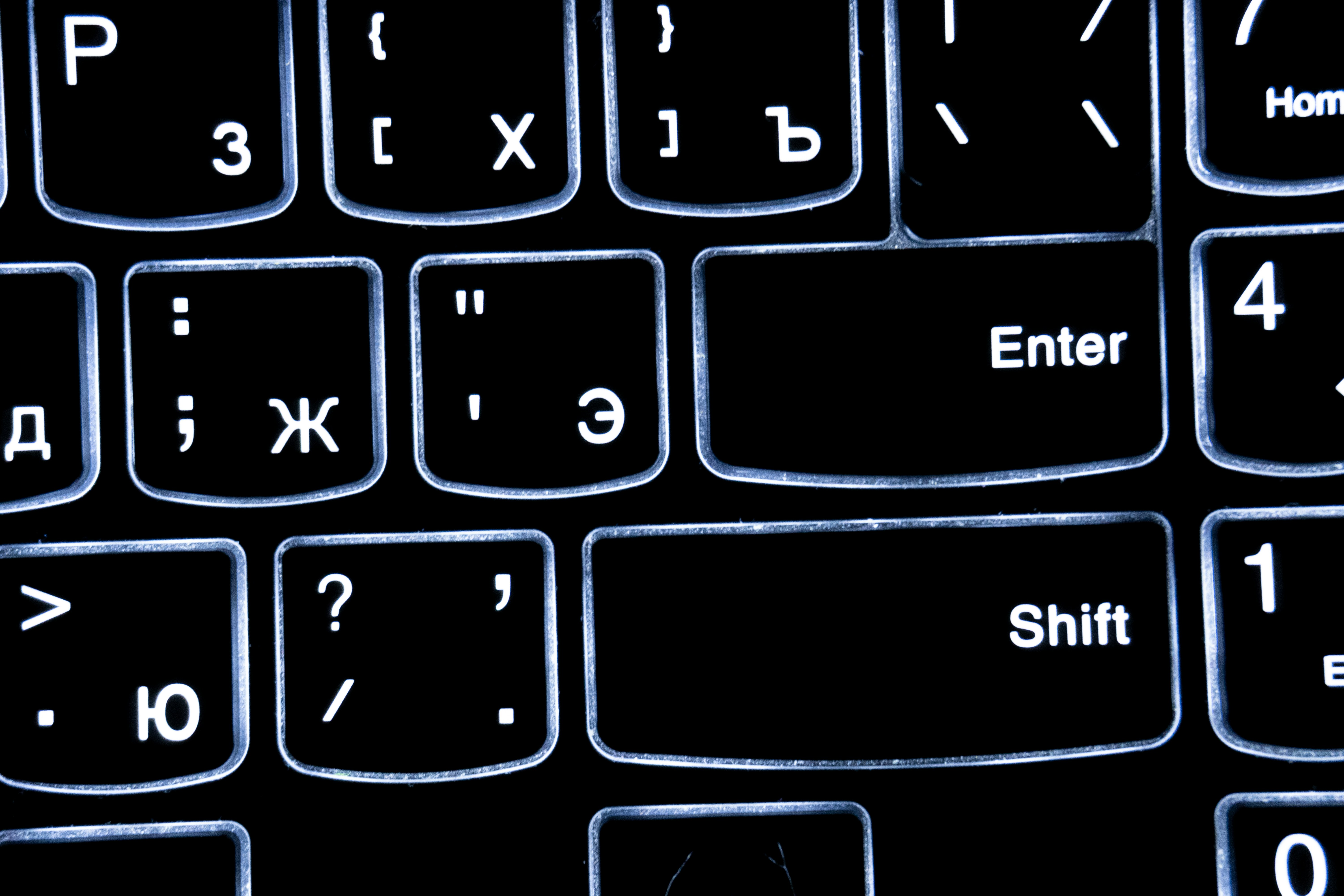 Close-up of a backlit keyboard with cyrillic letters.