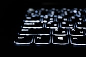 Close-up of a backlit keyboard in the dark.