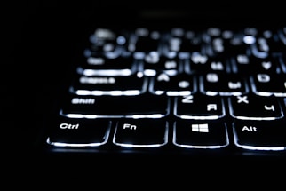 Close-up of a backlit keyboard in the dark.