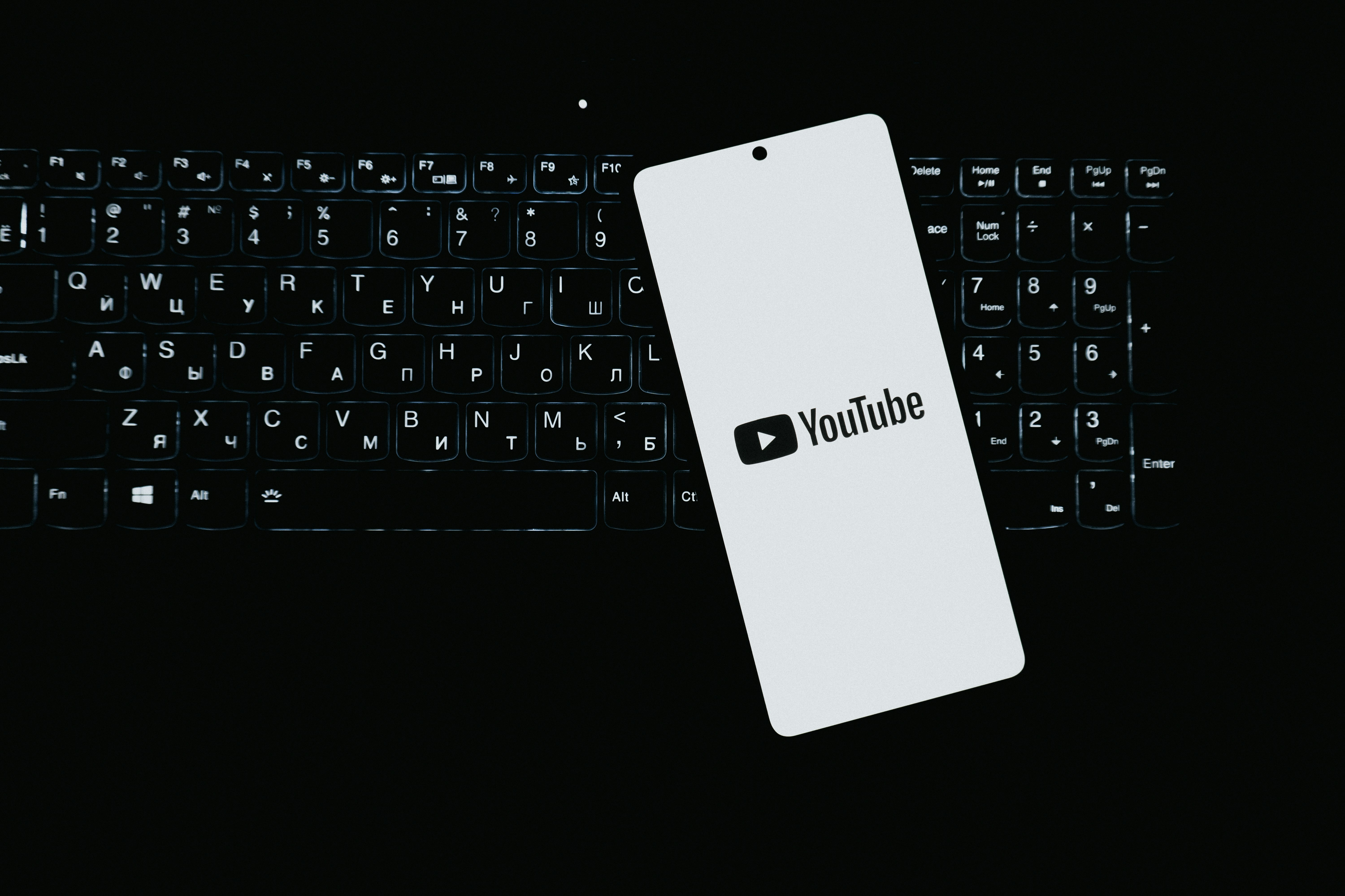 Smartphone with youtube logo on keyboard