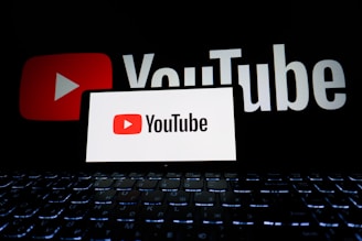 Youtube logo displayed on a phone and background.