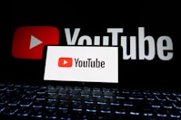 Youtube logo displayed on a phone and screen.