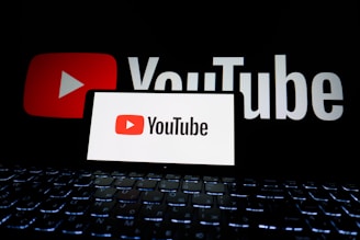 Youtube logo displayed on a phone and screen.