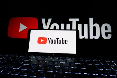 Youtube logo displayed on a phone and screen.