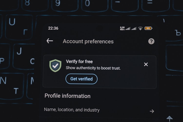 Smartphone account preferences screen showing a verification prompt, illustrating the SMS code mechanism hackers exploit for Statewins access