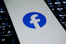Facebook logo on a laptop keyboard.