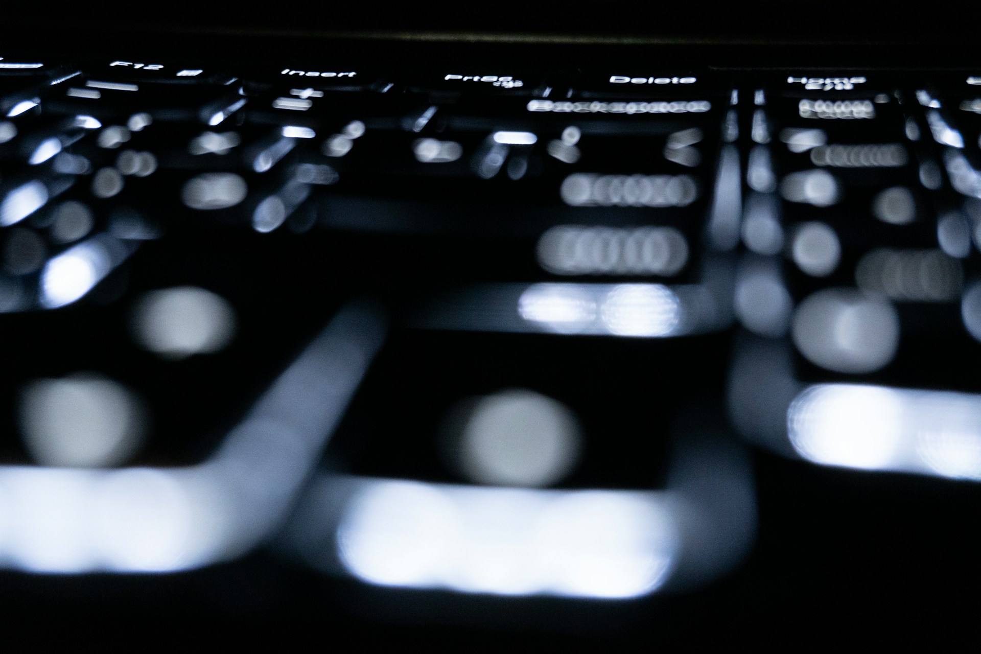 Close-up of a backlit keyboard in the dark.