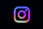 Instagram logo with colorful gradient on black