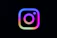 Instagram logo with colorful gradient on black