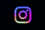 Instagram logo with colorful gradient on black
