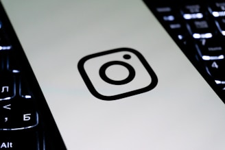 Instagram logo on a white surface with keyboard.