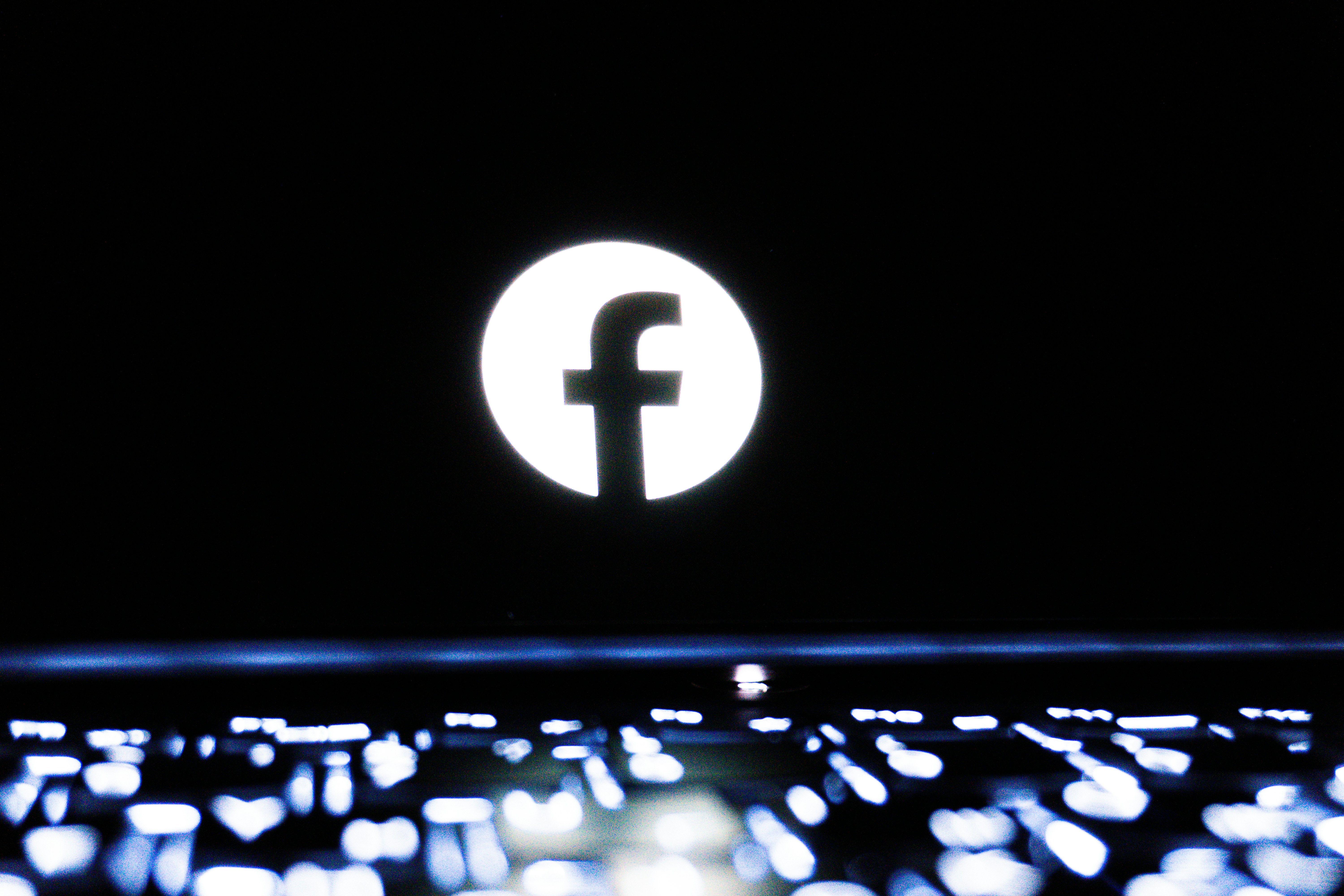 Facebook logo displayed on a dark background.