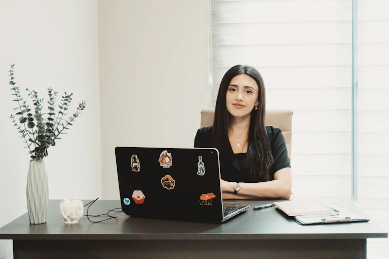 woman seated at a desk with a laptop