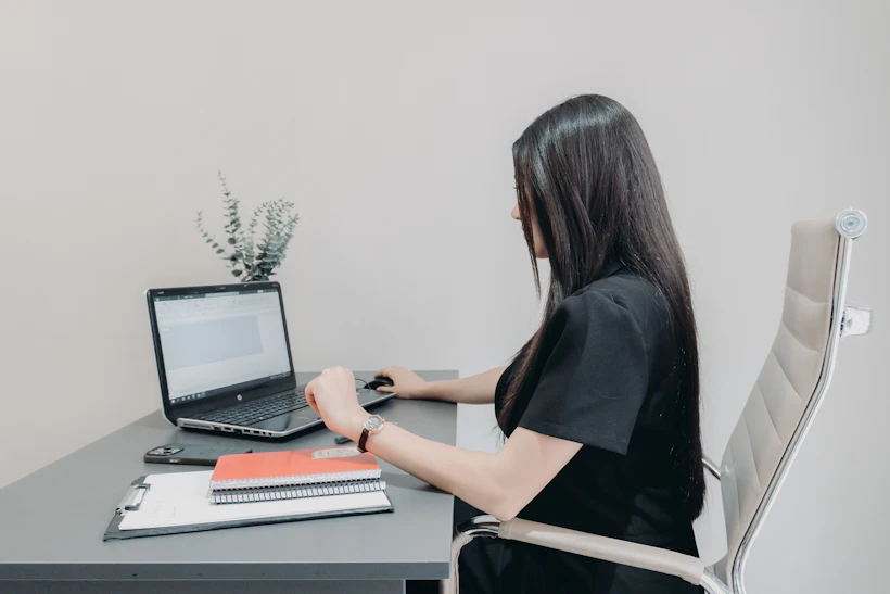 A professional working at a laptop in a quiet office