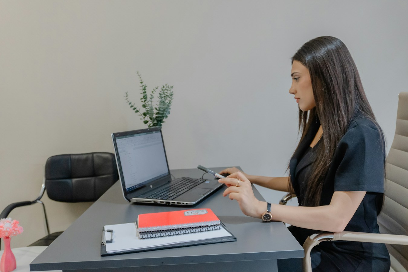 Woman working on a laptop at a desk