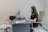 Woman working on laptop at desk in office