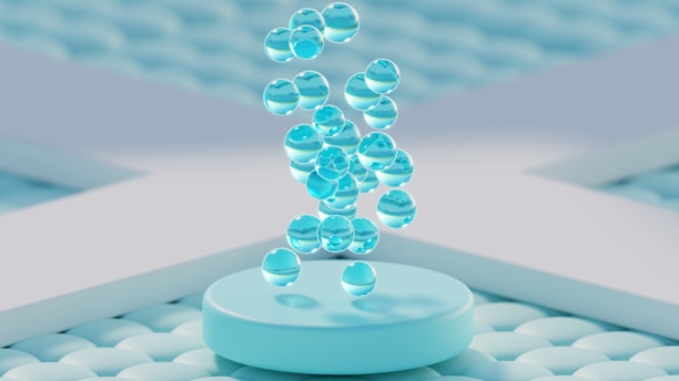 Clear water droplets falling onto a light blue podium.