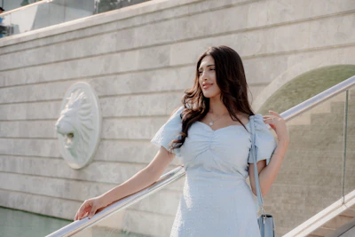 Young woman in light blue dress on stairs