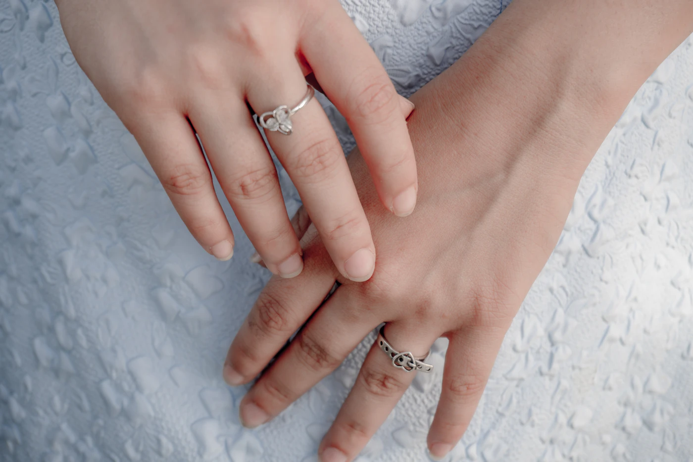 Hands wearing stacked rings — atelier detail, portrait placeholder