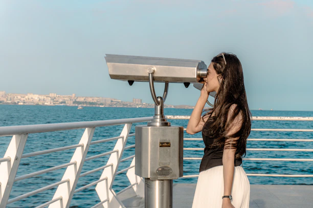 Woman sightseeing at a coastal destination while exploring things to do during her trip.