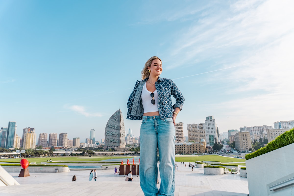 A wide cinematic horizontal fashion composition with a model placed deliberately in the frame