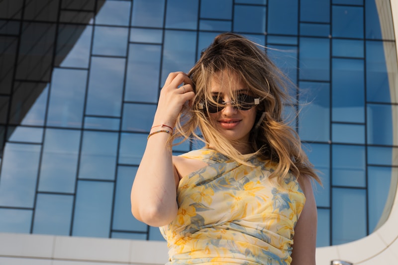 Stylish sugar mama with sunglasses near contemporary building