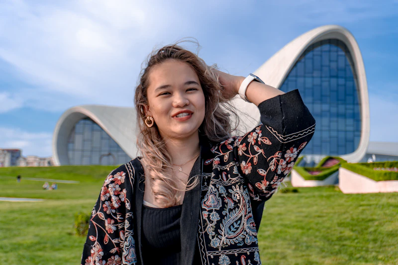 young curvy woman in patterned jacket outdoors