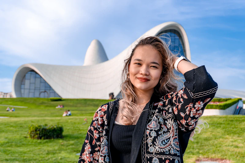 young woman posing by bold modern architecture