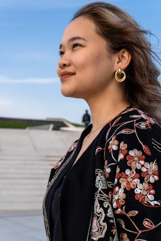 Young woman with floral jacket looks up