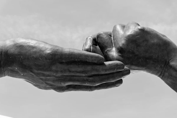 Hands gently supporting one another
