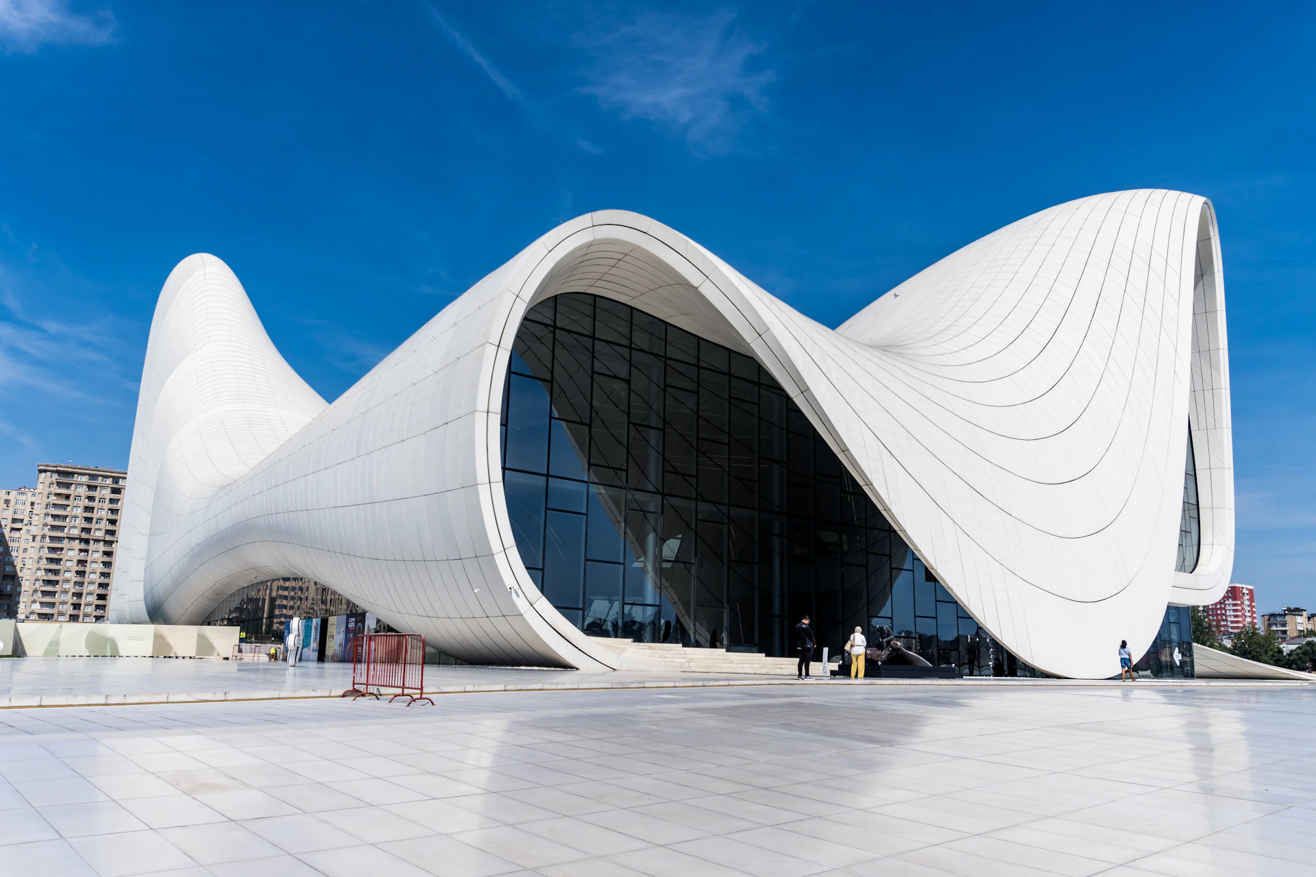 Modern white building with curved architecture under blue sky