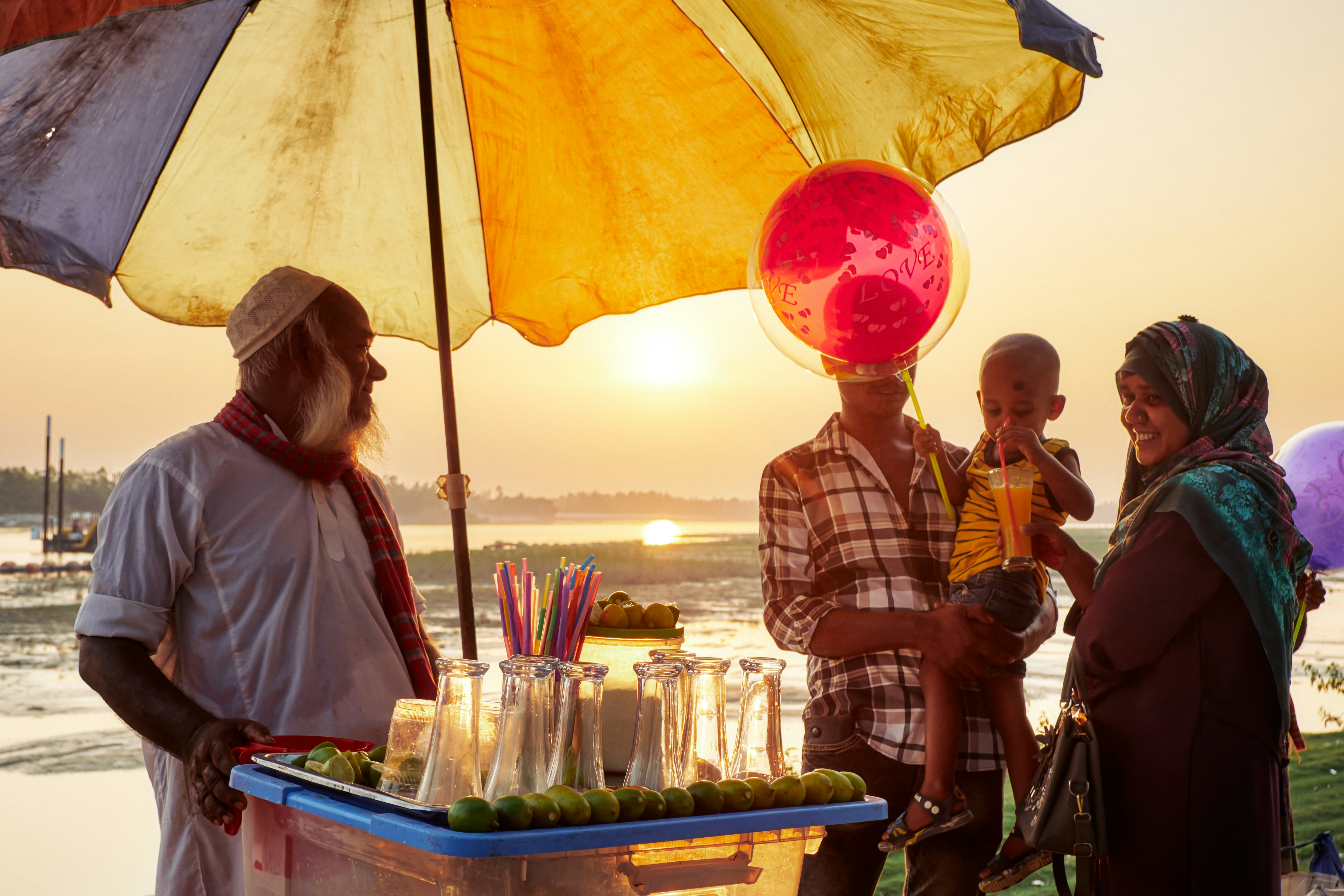 People at a street stall during sunset