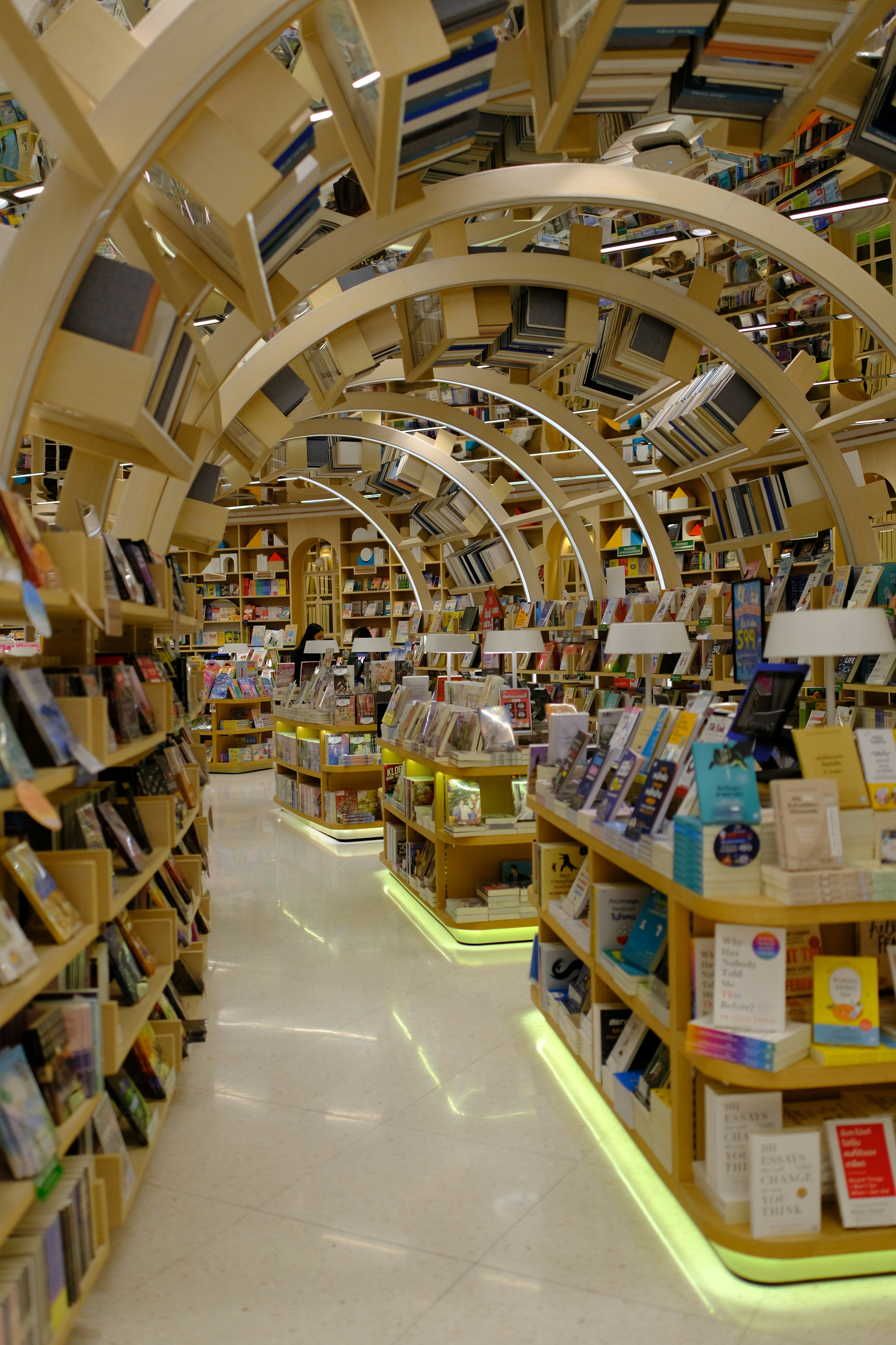 Interior of a modern bookstore with arched shelves.