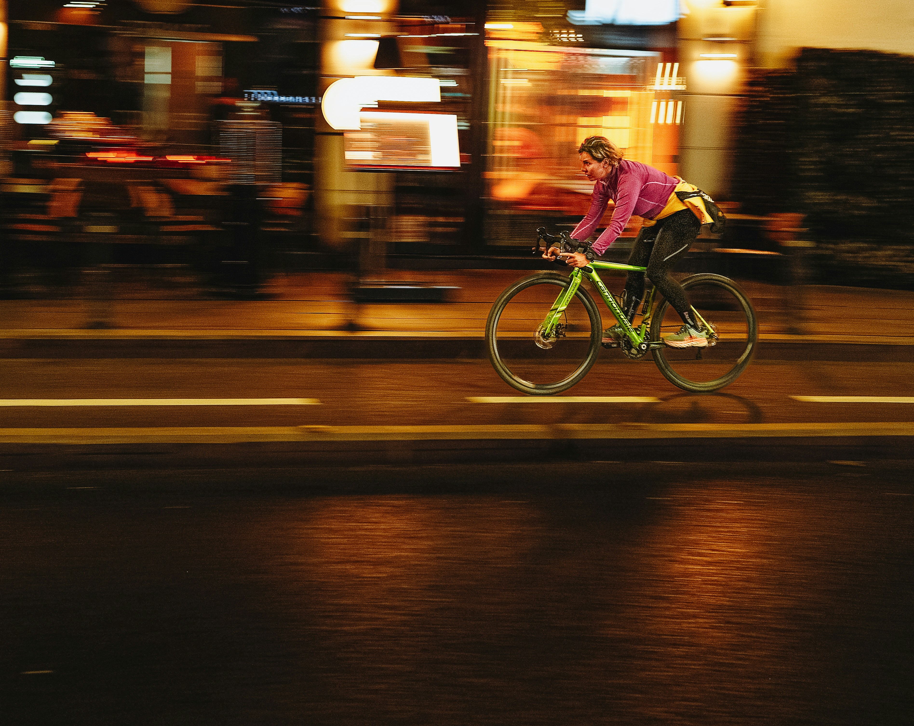 Person cycling on a street at night