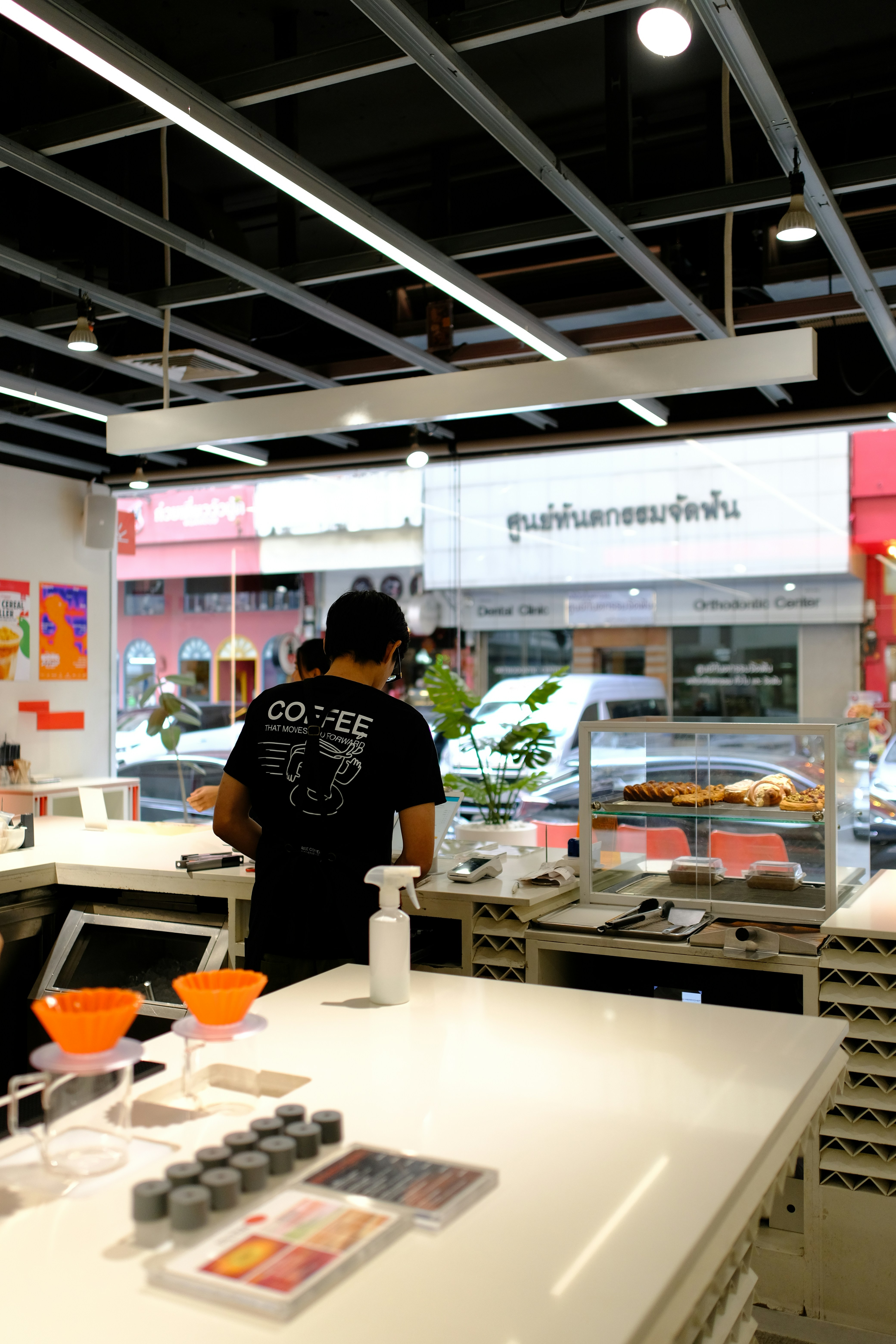 Barista working behind a counter in a cafe.