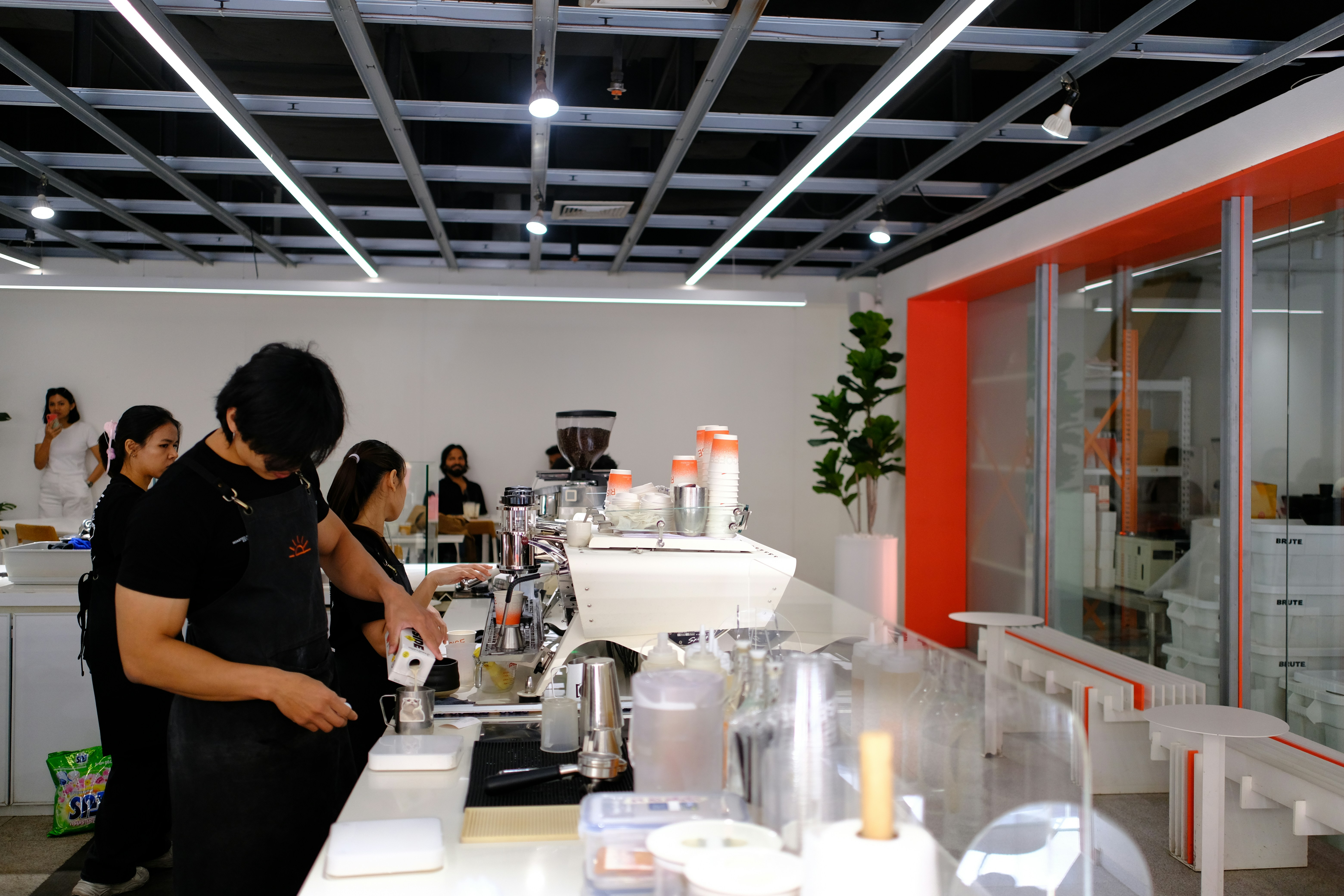 Baristas preparing coffee behind a counter