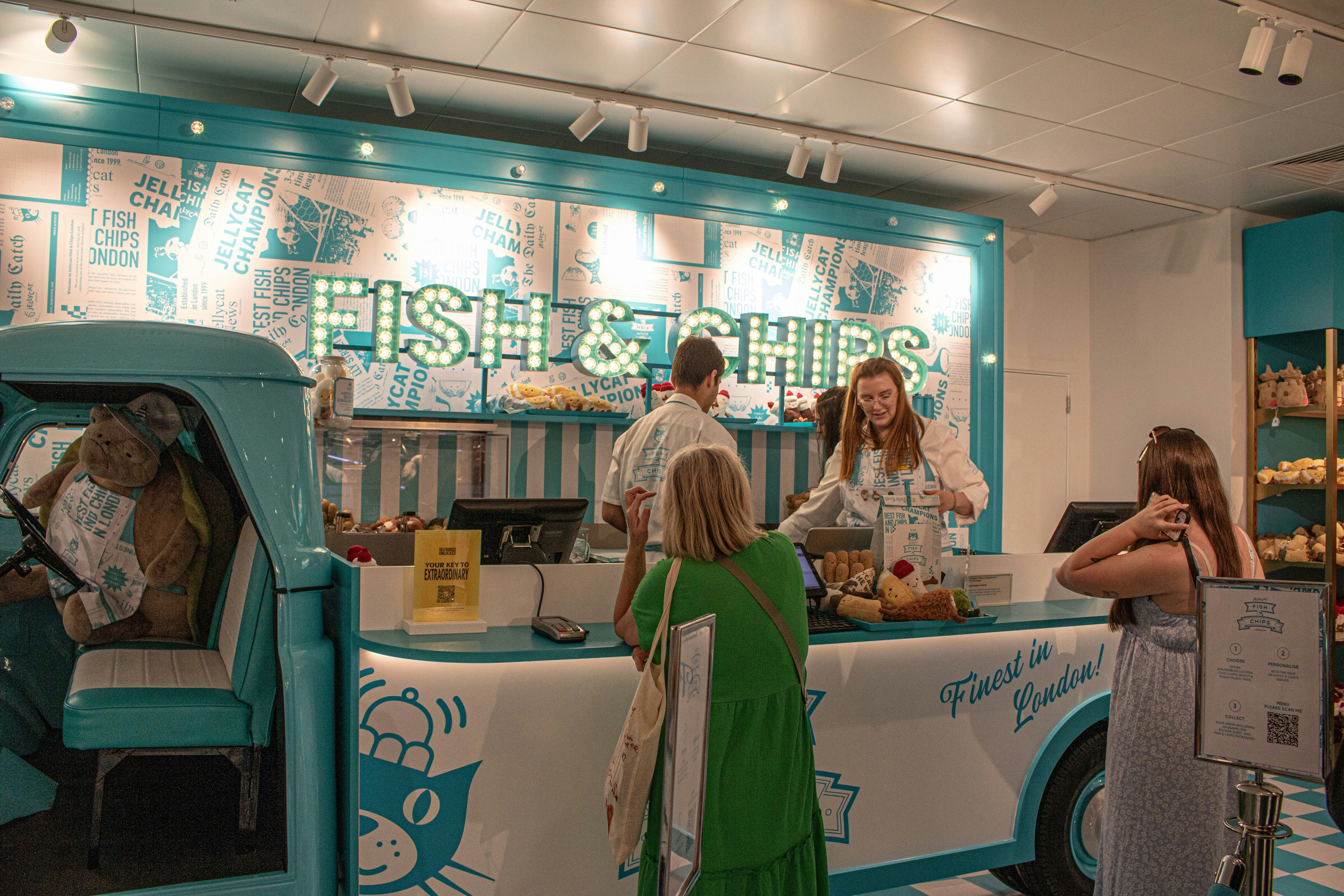People ordering fish and chips at a counter