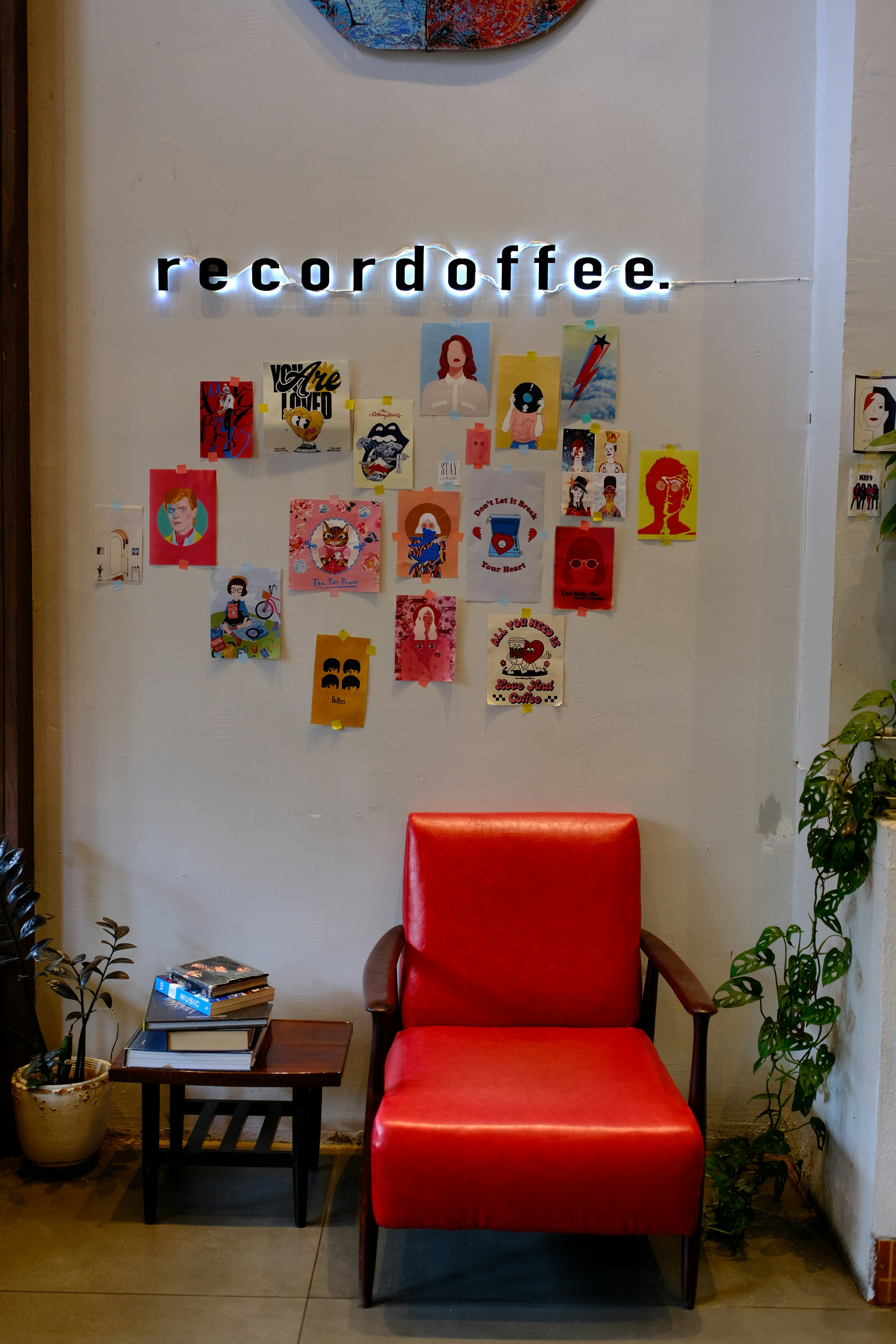 Red chair with artwork on wall