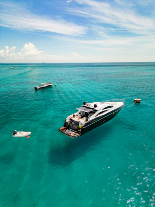 Luxury yacht anchored in clear turquoise ocean water