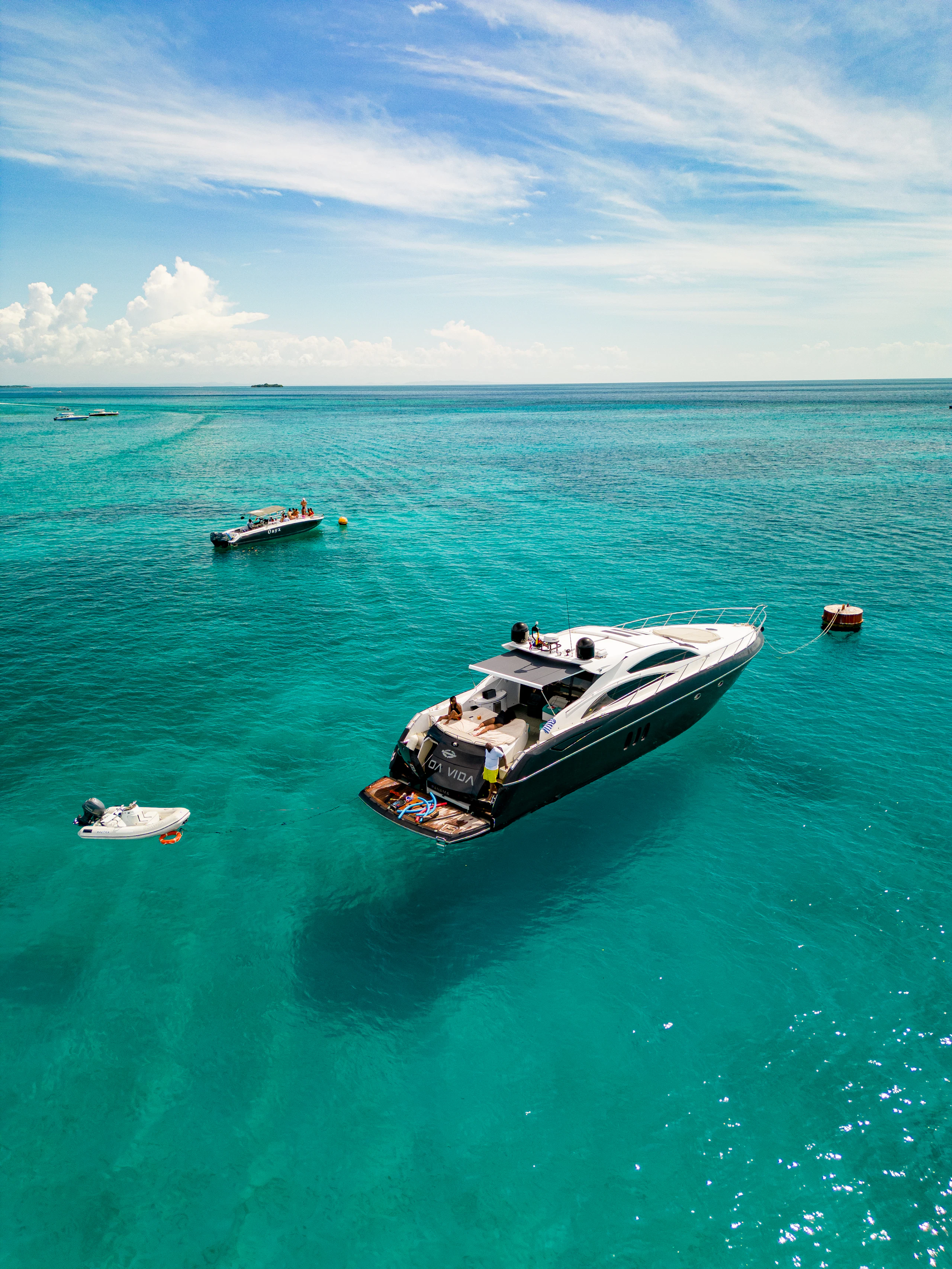 Luxury yacht anchored in clear turquoise water