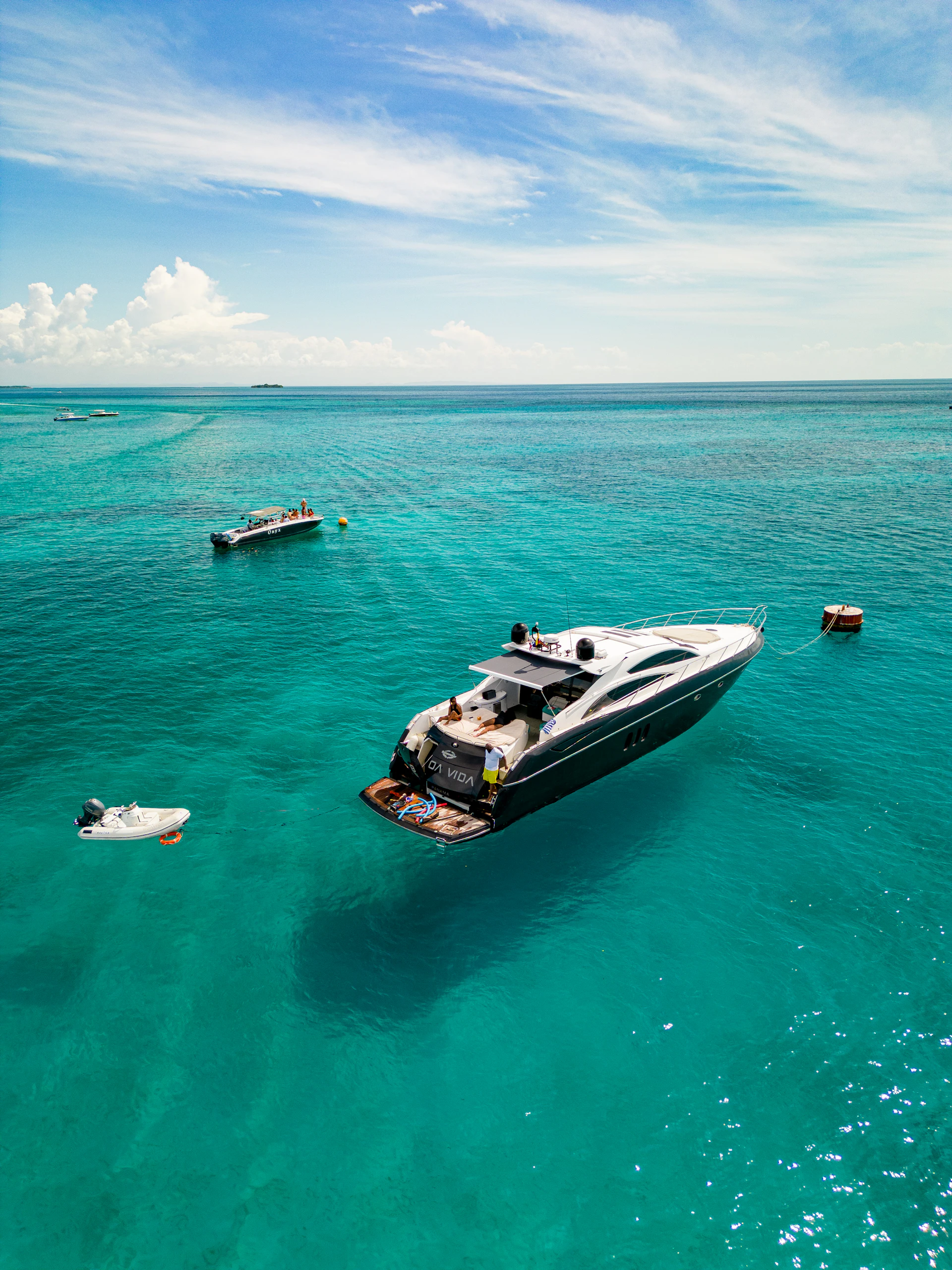 Luxury yacht anchored in turquoise ocean waters