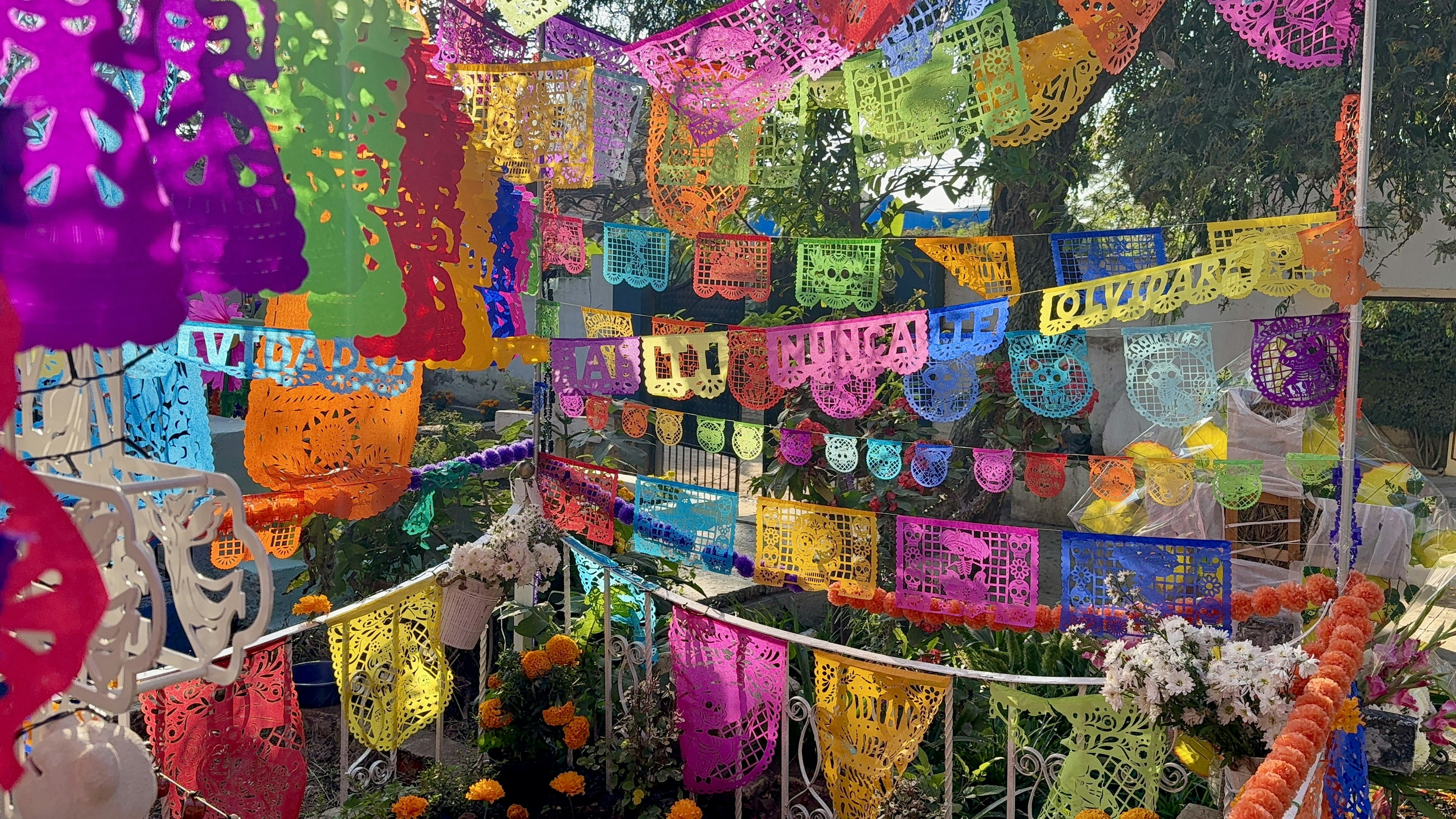 Colorful papel picado banners strung across outdoor space